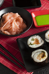 Sushi rolls, wasabi and ginger in a bowl