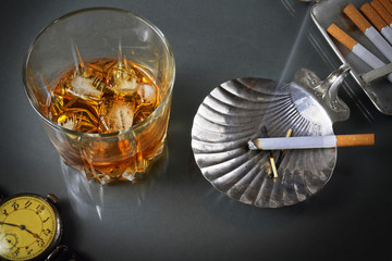 Still life with a whisky glass and cigarettes in a retro style