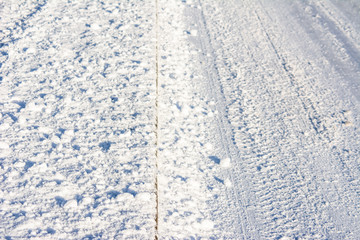 Tracks in snow on road in winter, transportation concept