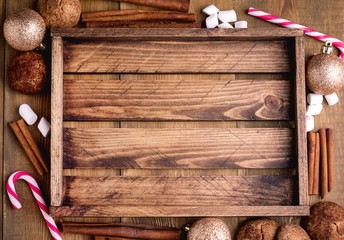 Cristmas background with place for text Topp view Wooden background Wooden tray Cookies Candy cane Cinnamon sticks Christmas card