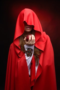 beautiful woman holding red apple in studio