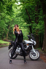Plakat An attractive sexy girl on a sports motorbike posing outside