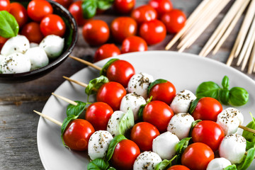 Caprese salad - mozzarella basil and tomato skewers, italian food and healthy vegetarian diet concept