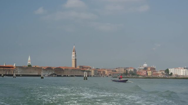 View from Venice Italy from a ferry passing by rowing sporters