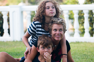 Family composed of a mother, son and daughter on vacation and very cheerful