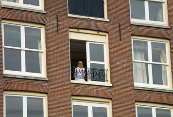 blonde girl at the apartment building window