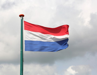 Fototapeta na wymiar waving Dutch flag with white and blue red and cloudy sky