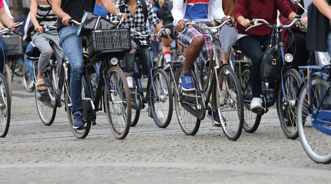 Fototapeta people riding bicycles in Amsterdam in the Netherlands