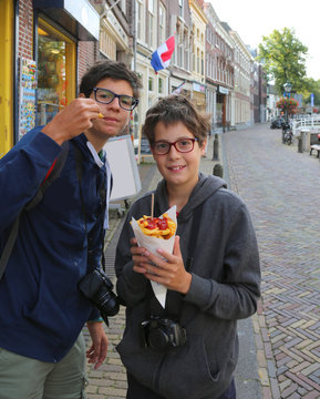 Two Cute Kids Eat French Fries On The Road