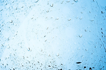 Background of water drops on windshield in a rainy day.
