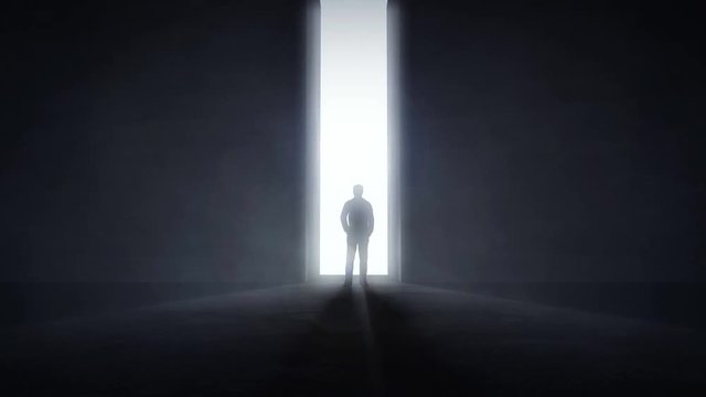 Man standing in the front of an opening wall with light coming trough