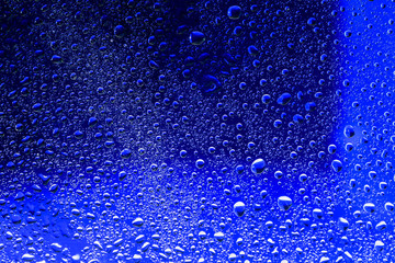 Drops of water on blue surface. Macro abstract photo, background, texture