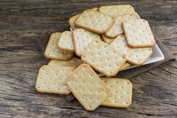 cracker on old wooden surface background, selective focus.