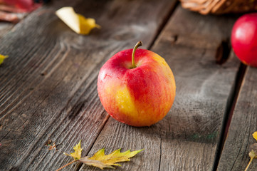 Close up fresh Ripe organic one red apple with water drops on the rustic wooden table. Space for text. Selective focus. Autumn harvest concept. Vegetarian, vegan, healthy diet food.