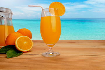 Orange juice in glass and fresh citrus around  on wooden table background fruit product display or montage