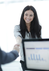 business woman welcomes colleague with handshake