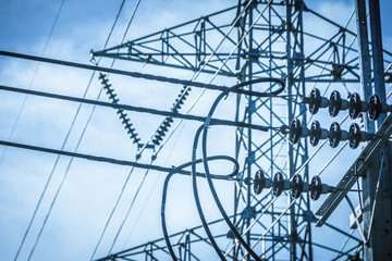 Electricity station. Close up high voltage power lines at sunset.