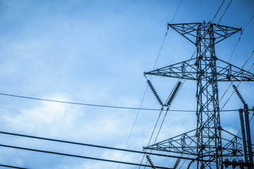 Electricity station. Close up high voltage power lines at sunset.