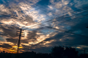 Electricity station. Close up high voltage power lines at sunset.