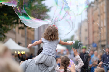 A holiday of soap bubbles in a city street. Riga, Latvia