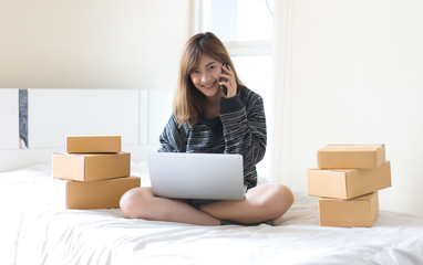 Young woman start up small business entrepreneur or freelance woman working online marketing...
