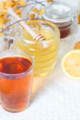 pouring honey into cup of tea