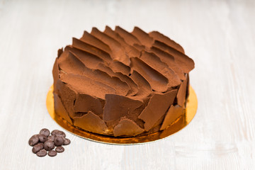 The chocolate cake on the table without spoons