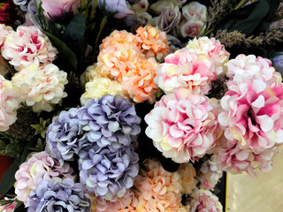 A bouquet of roses made of fabric. Bouquet of roses sold in the market. Beautiful colorful flowers in flower shop.