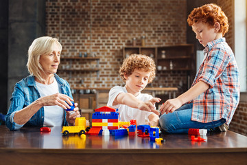 Curly haired little boys spending time with granny