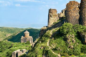Obraz premium View of a part of an ancient fortress Amberd in Armenia with a medieval cathedral on the background 