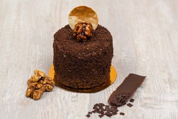 The chocolate cake with walnuts on the table