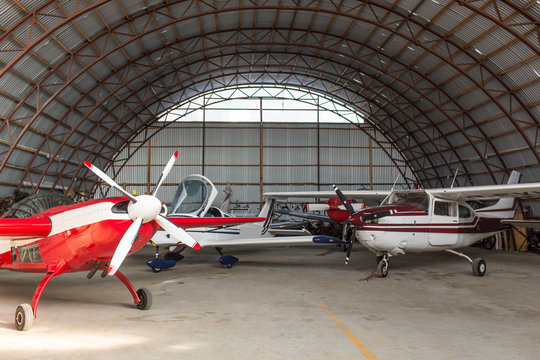 Interior view of airplanes parked in hangar