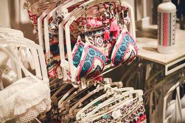 Fashion underwear, clothing hanging on hangers. Closeup on group of accessory, household showroom department