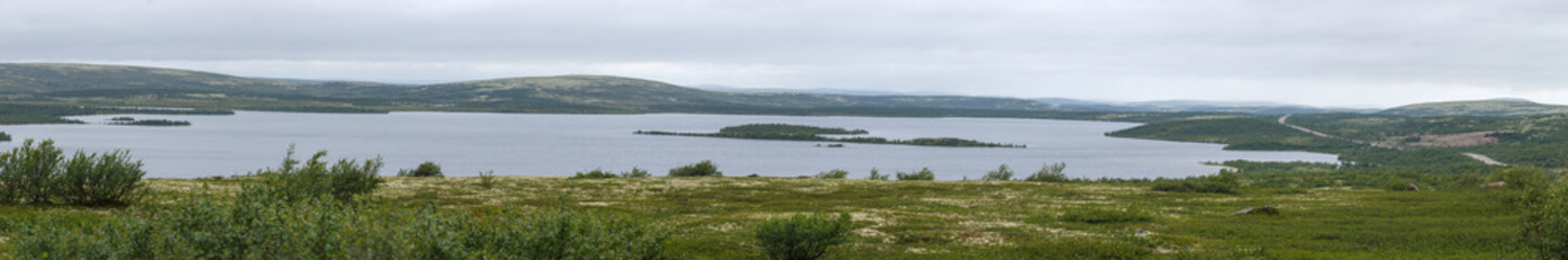 Fototapeta na wymiar Panoramic view of the lake in the tundra of the Kola Peninsula. The Arctic, Russia.