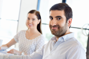 Image of two young business people in office