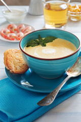 Bowl of cream soup with shrimps and bread