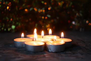 Burning candles on Christmas decoration background.
