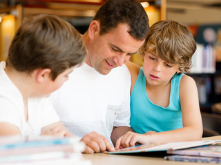 Father with sons in library