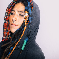 Portrait of Latin girl with dreadlocks and piercing. Street fashion style
