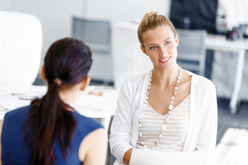 Two female colleagues in office