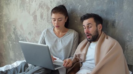 Loving wife helping her sick husband with work