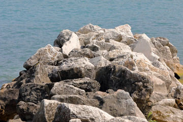 Big rocks form a cliff on the sea