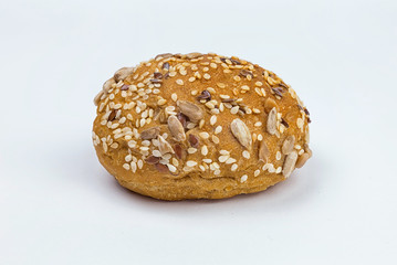 Rye bun seeded on a white background, macro