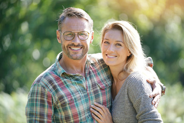 Portrait of mature couple enjoying sunny day in nature