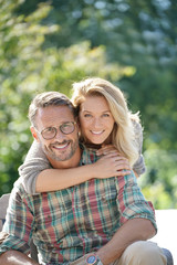 Fototapeta premium Portrait of mature couple enjoying sunny day in nature