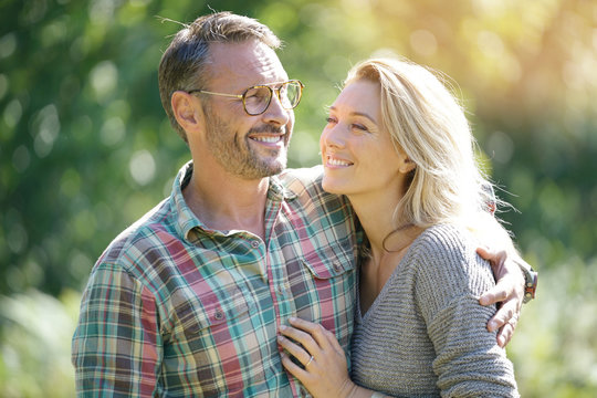 Portrait of mature couple enjoying sunny day in nature