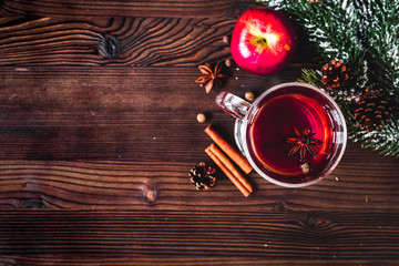 cup with christmas mulled wine on wooden background top view
