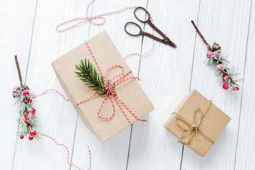 gifts boxes with fir branches on wooden background top view