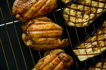 Chicken breasts and eggplants on a grill. Top view