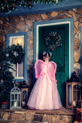 Obraz premium Girl in angel costume knocking at the door